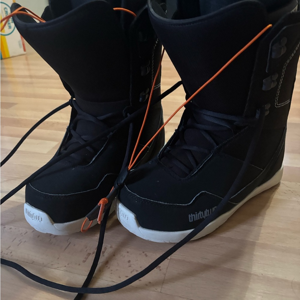 Thirty-two Black Snowboard Boots with Orange Accents